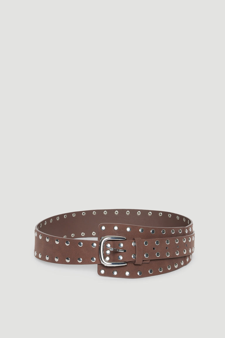 Brown studded belt with an oversized silver buckle and adjustable fastening
