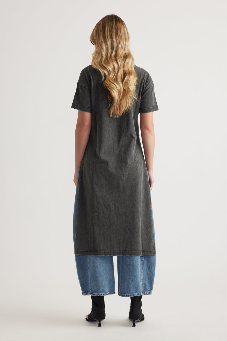 Woman wearing a charcoal longline tee with blue wide-leg jeans and black ankle boots