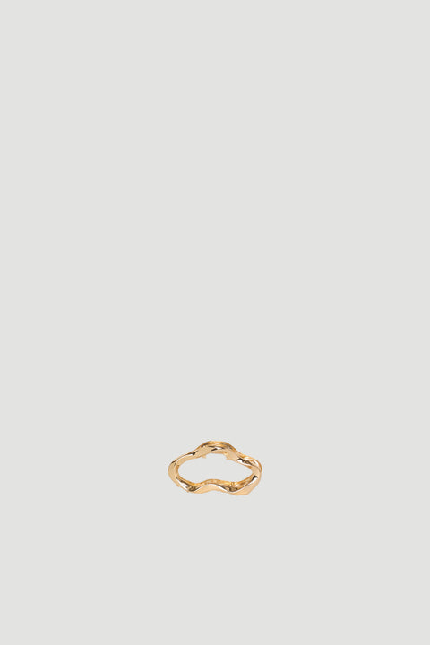 Small gold wavy hair claw clip on a neutral background