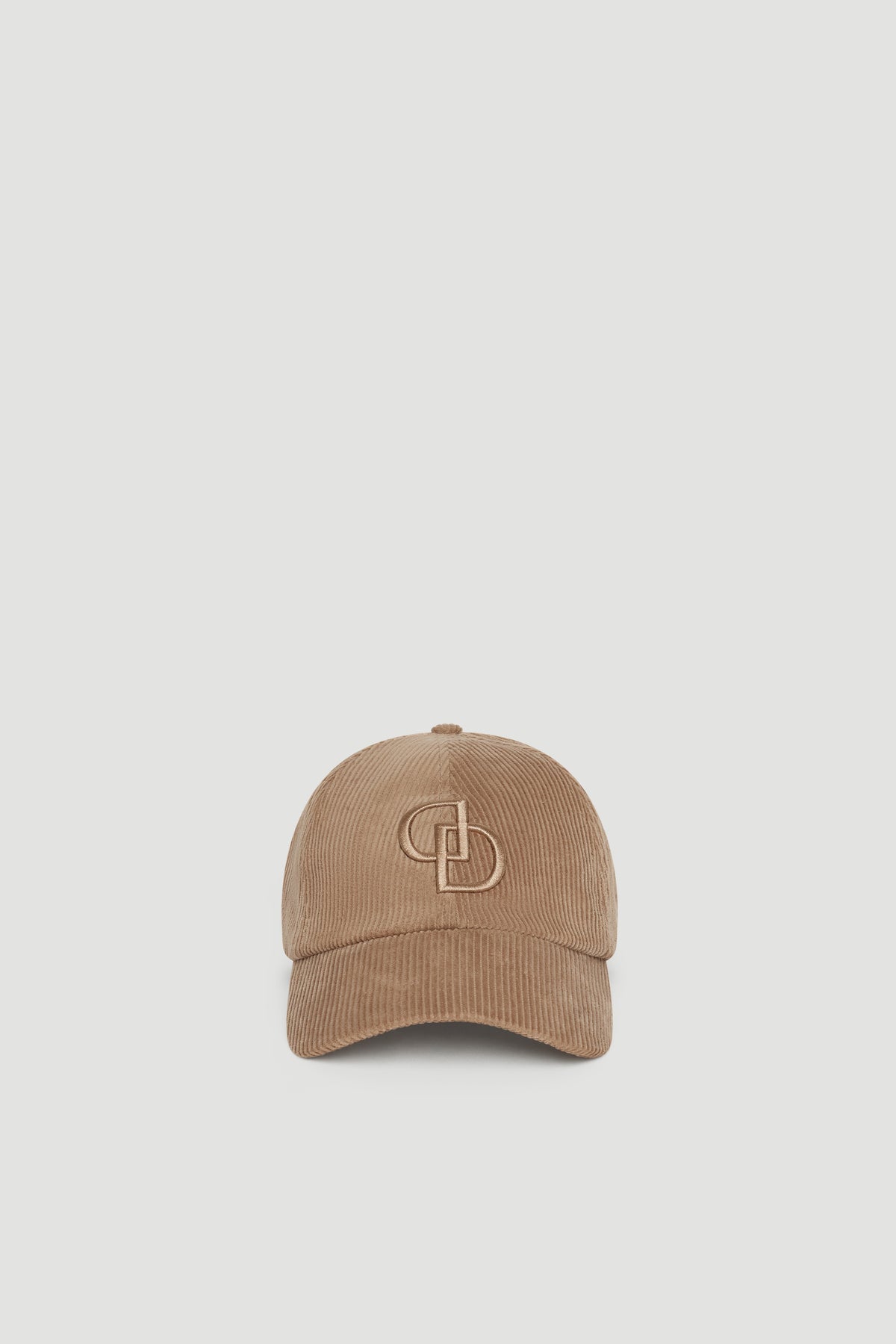 Corduroy baseball cap in mushroom tone featuring subtle embroidered branding for a relaxed, stylish look.