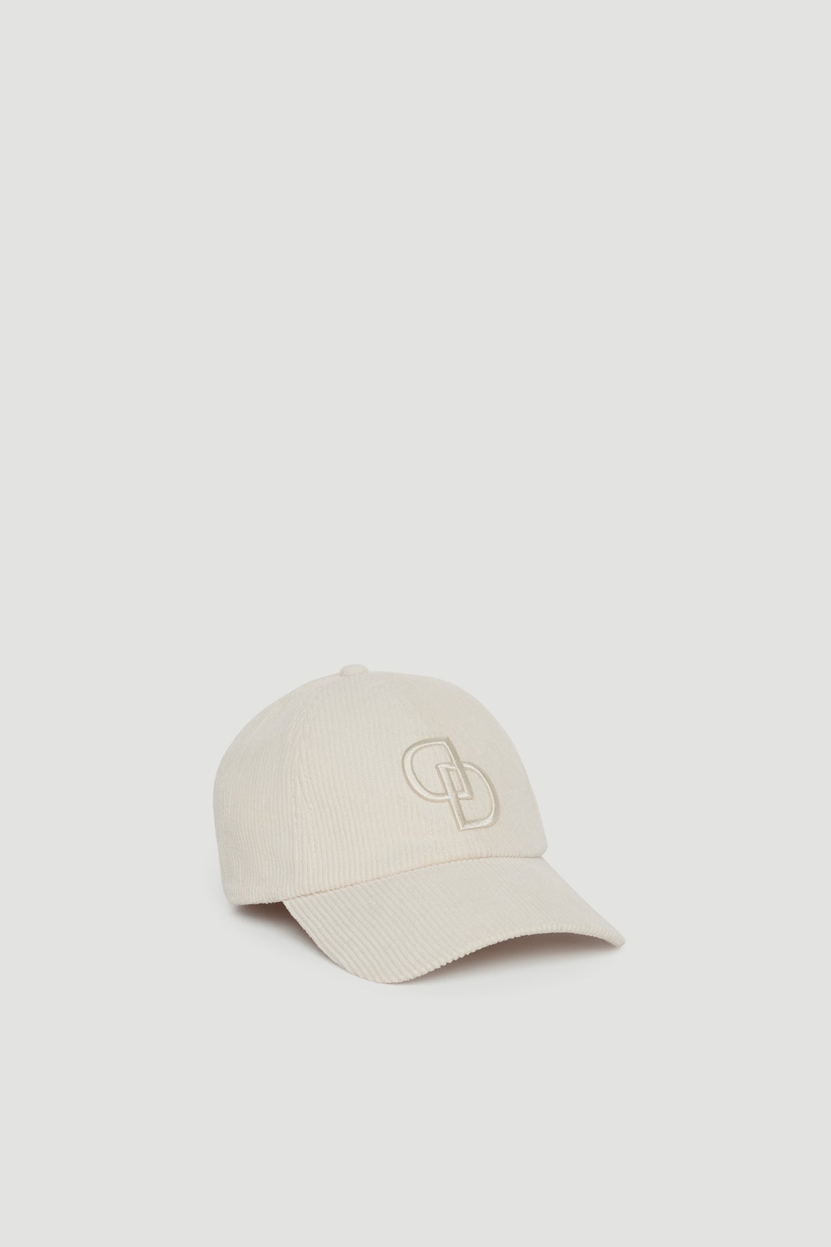 Soft vanilla cord fabric baseball cap with embroidered logo detail for a casual, polished touch