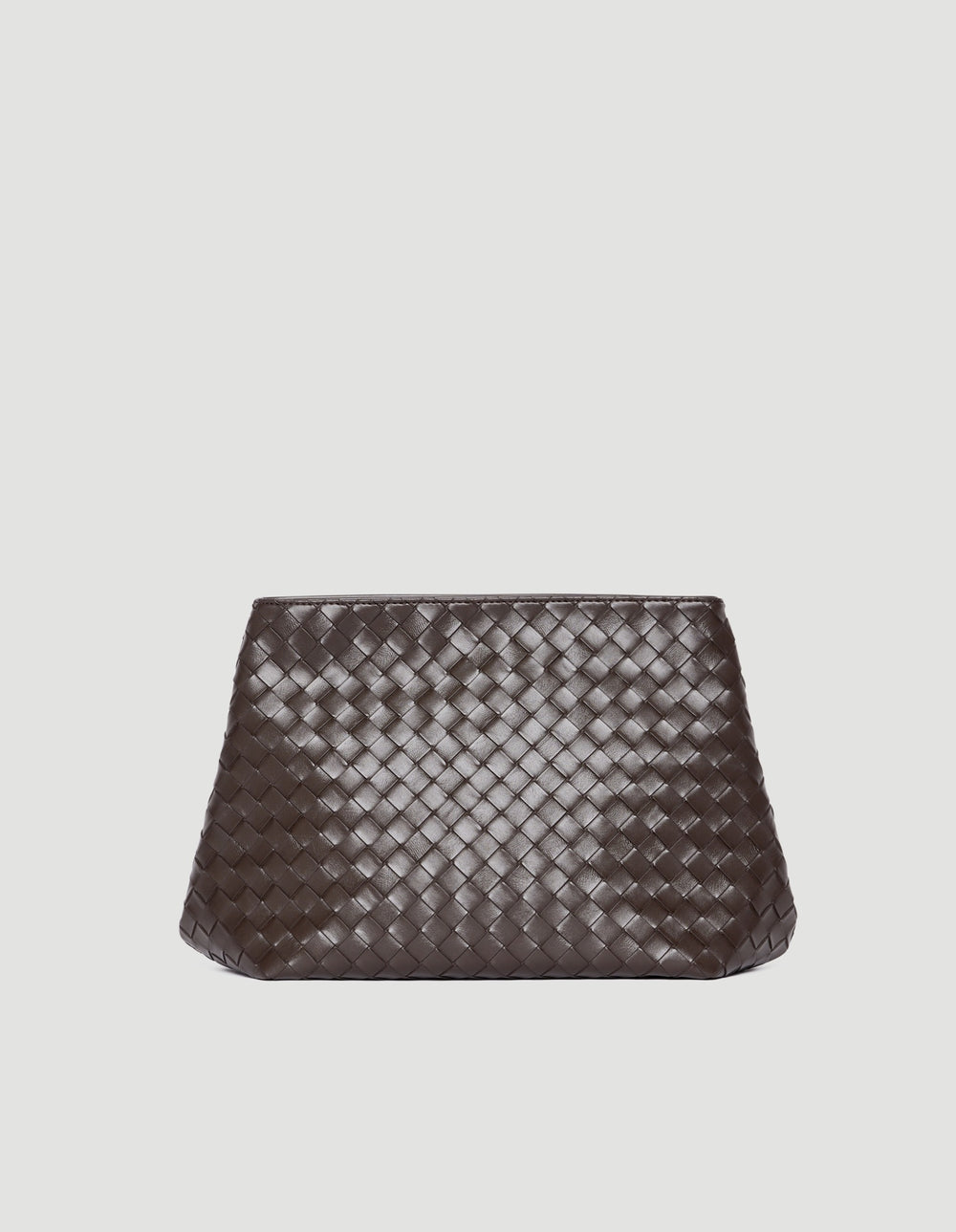 Dark chocolate brown clutch with woven texture and sleek, minimalist silhouette against a light background