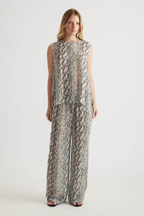 Woman wearing a snakeskin print sleeveless high neck tank with matching wide leg pants