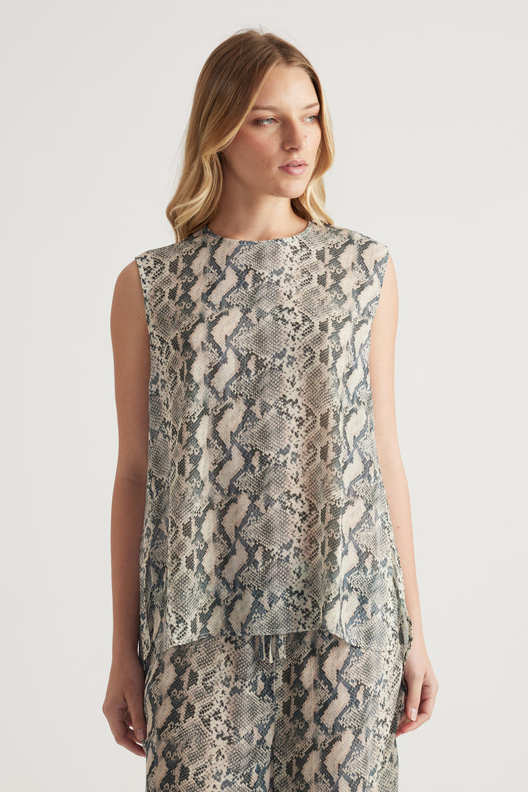 Woman wearing a high neck sleeveless snakeskin print tank top with matching pants