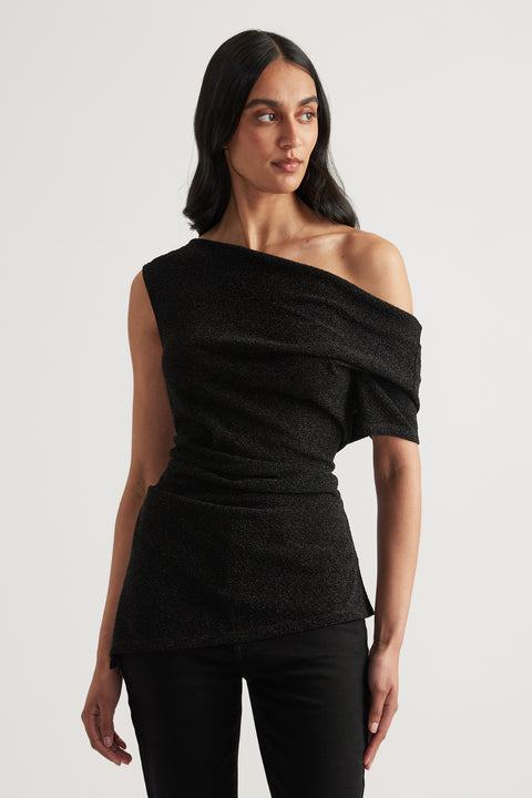 Woman wearing a black off shoulder top with an asymmetric neckline and hem