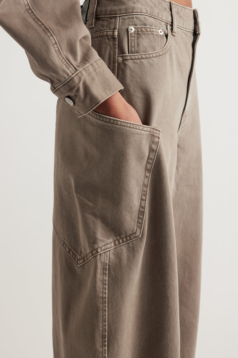 Taupe high rise cargo barrel jeans with structured denim and a large side pocket