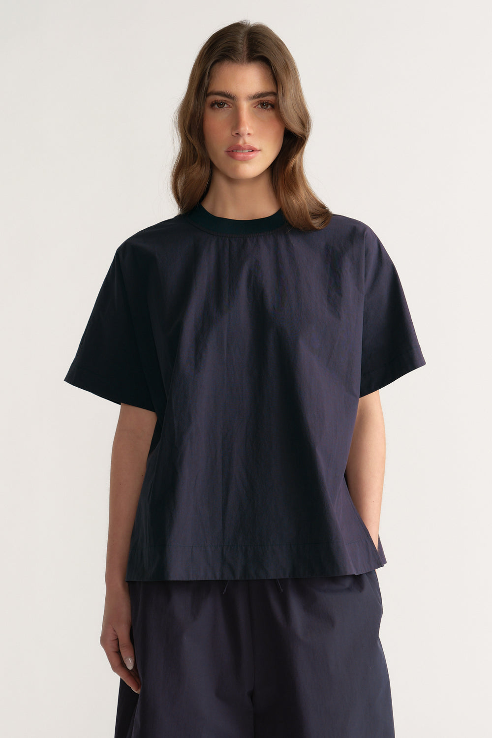 Woman wearing an oversized navy short sleeve crew neck top with matching pants