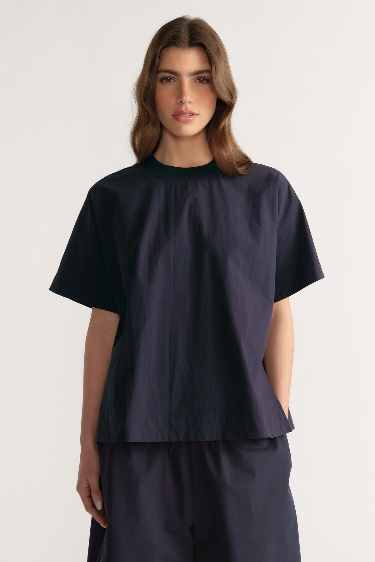 Woman wearing an oversized navy short sleeve crew neck top with matching pants