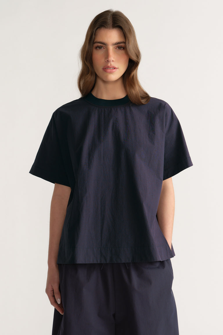 Woman wearing an oversized navy short sleeve crew neck top with matching pants