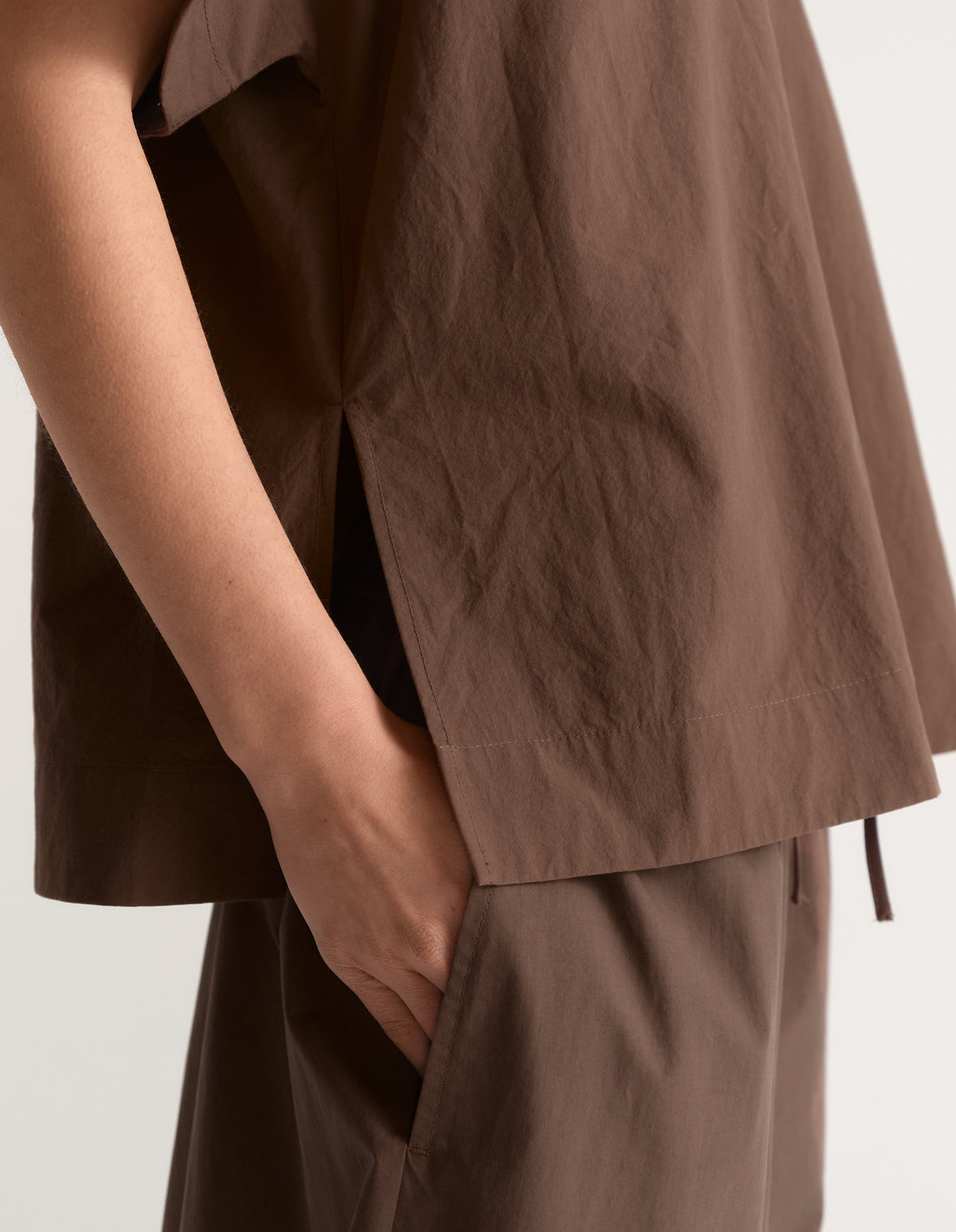 Woman wearing a brown boxy short sleeve top with matching relaxed pants