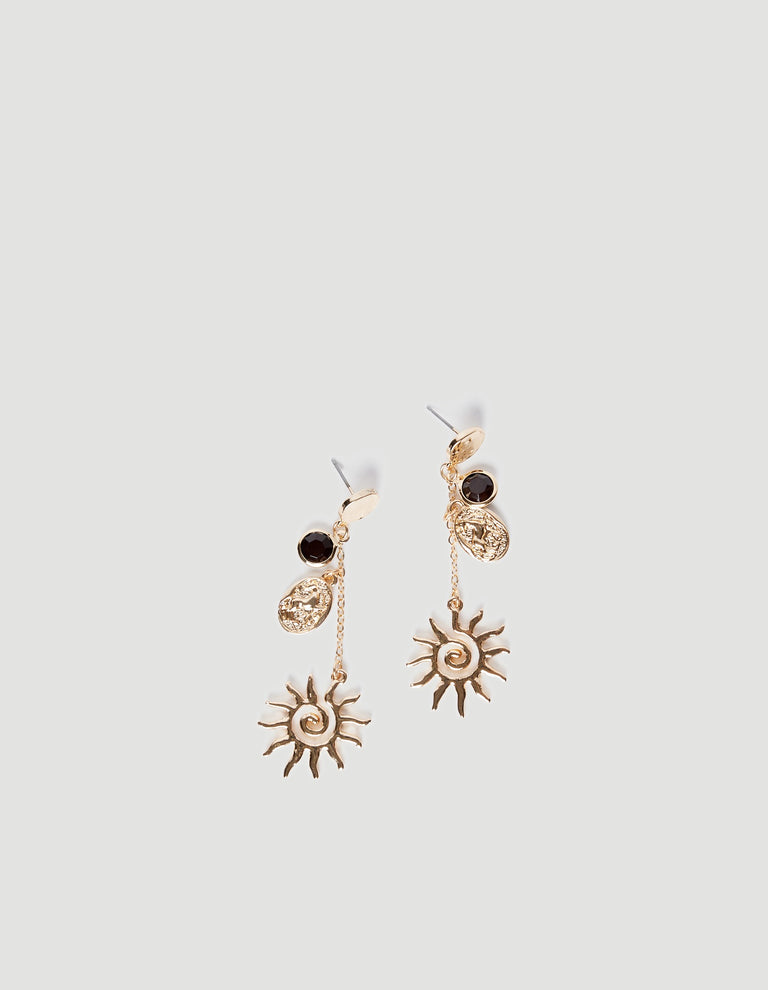 Pair of shiny gold drop earrings featuring sun motifs, textured pendants, and dark gemstone studs