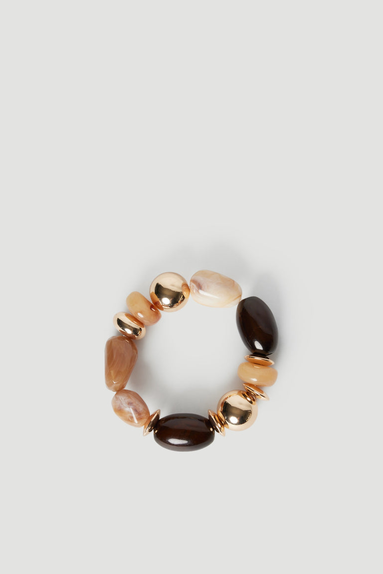 Elastic bracelet featuring a mix of neutral-toned stone and shiny gold-tone beads on a light background