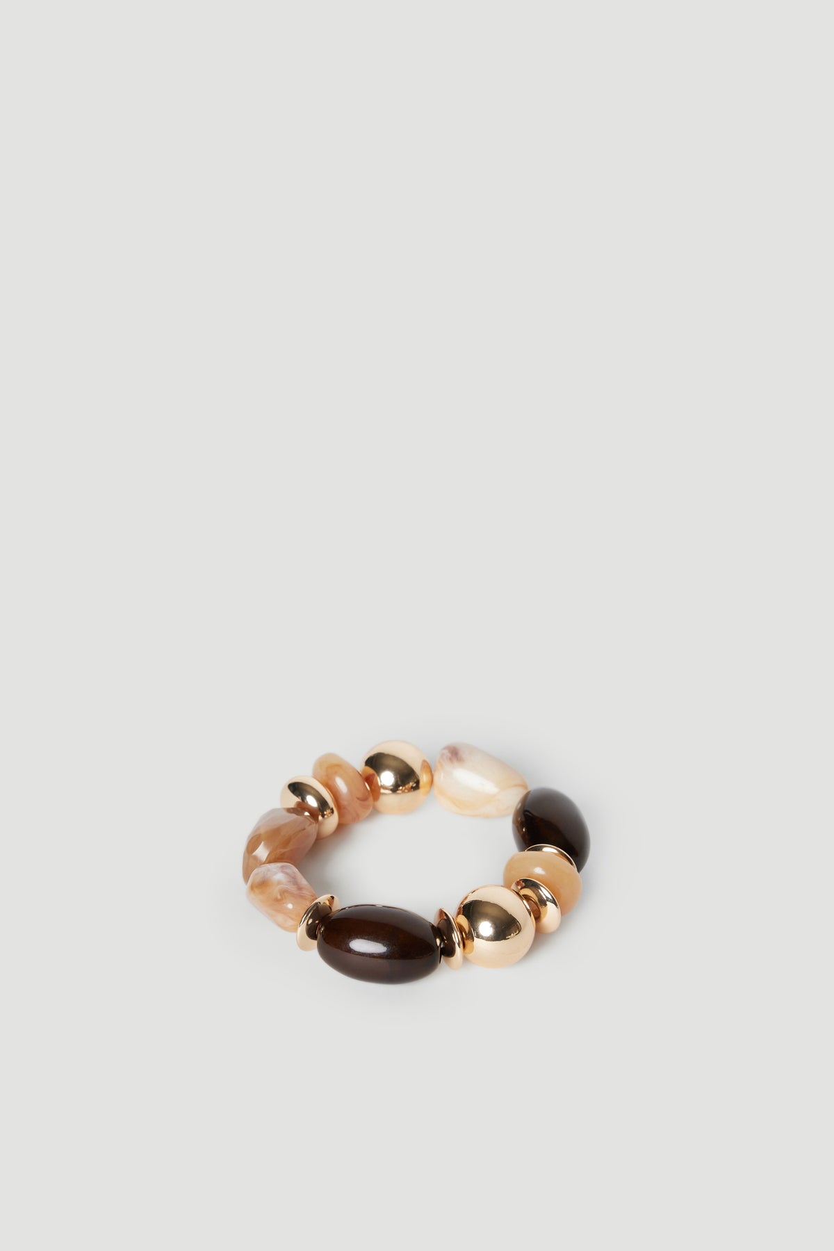 Elastic bracelet featuring mixed neutral-toned beads with polished gold accents on a light background