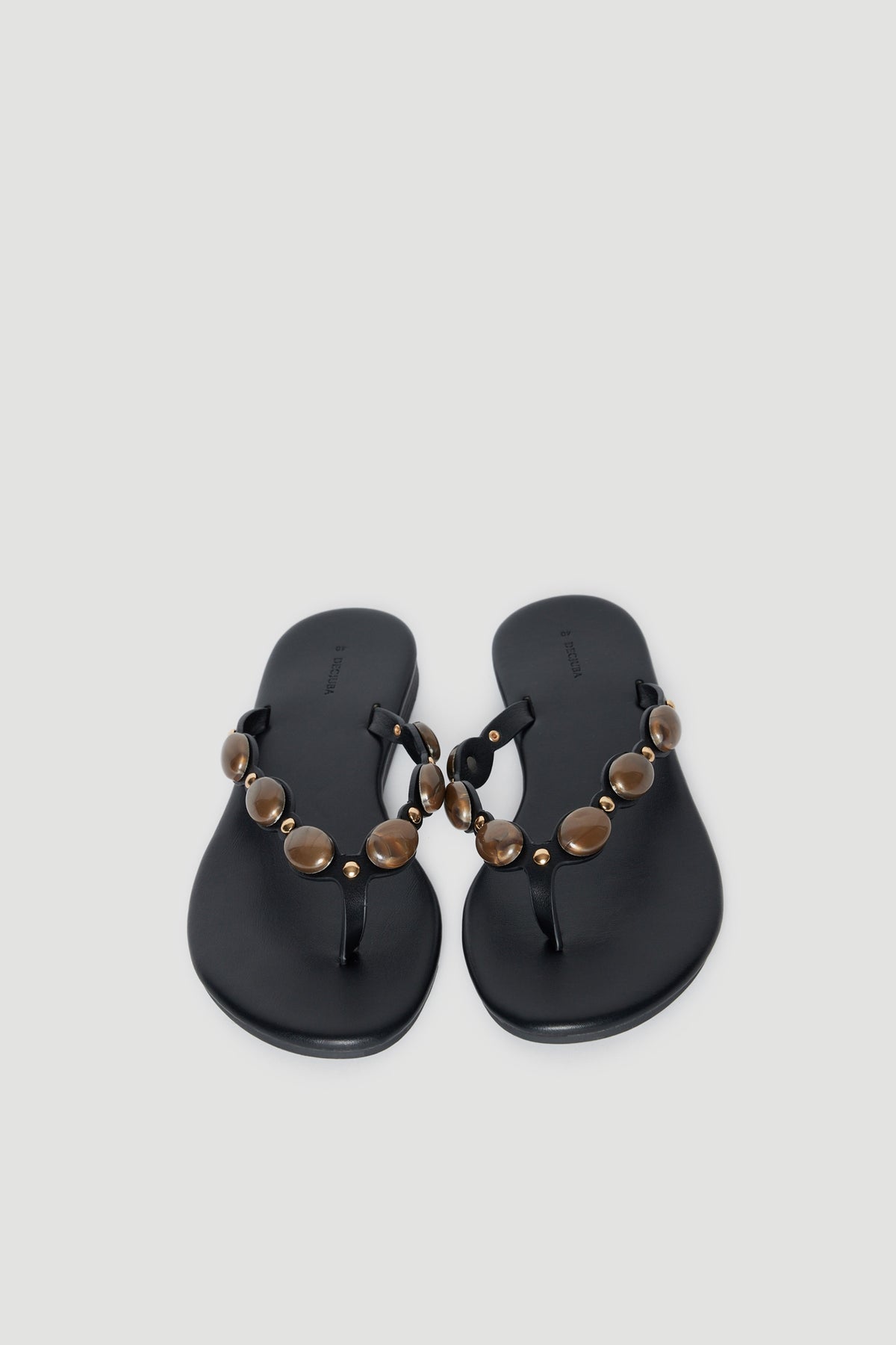 Black thong sandals with rounded gemstone embellished straps and cushioned footbeds