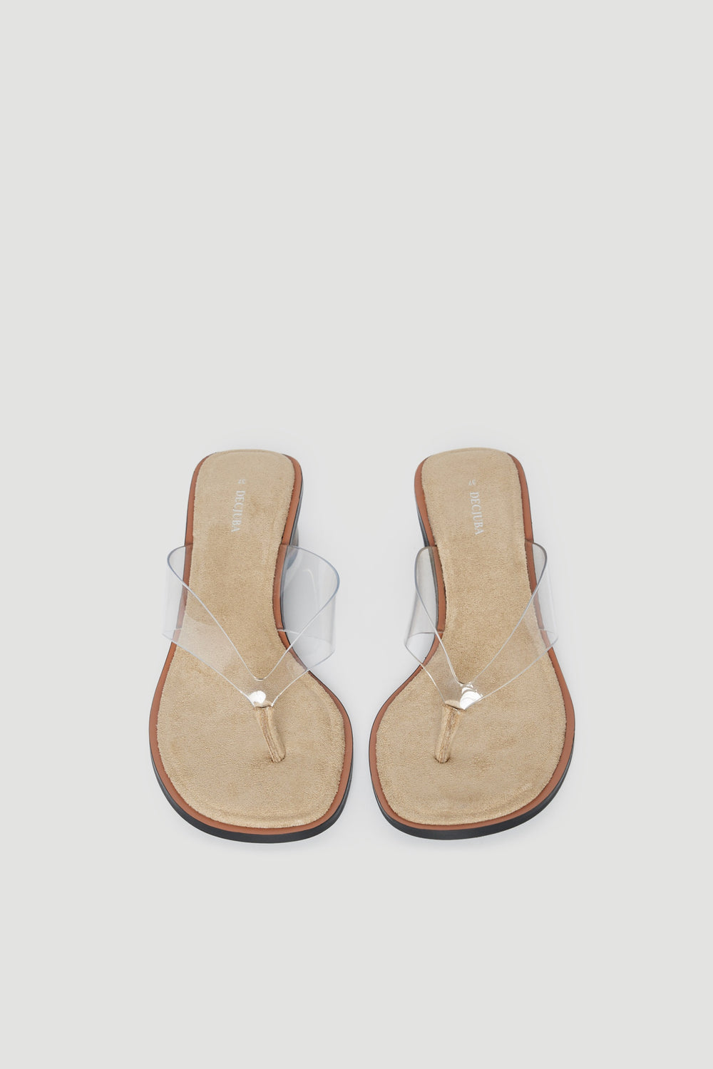 Pair of tan thong heels with transparent straps and medium block heels