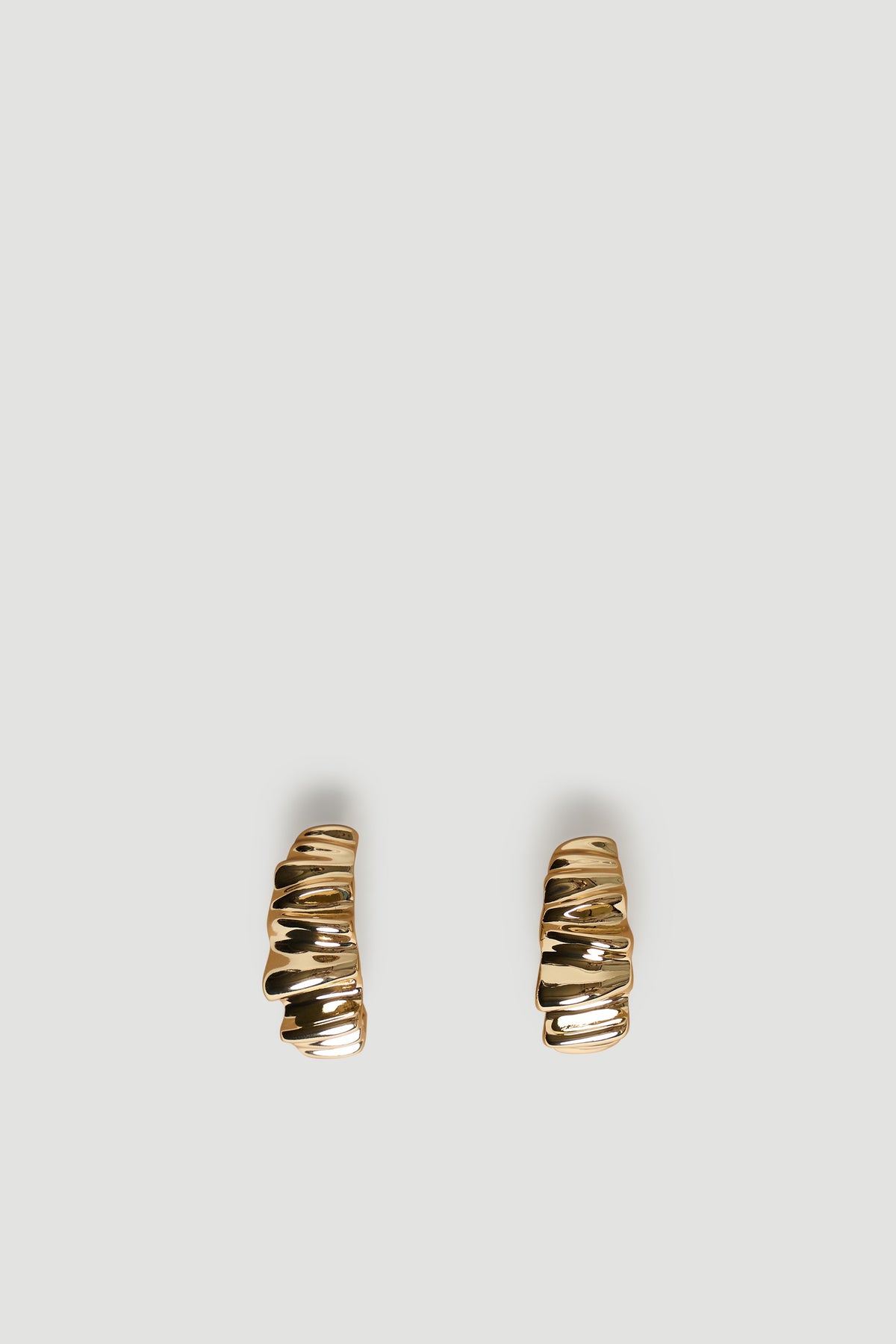 Pair of small gold-tone hoop earrings with a textured crinkle design for a subtle yet stylish everyday look.