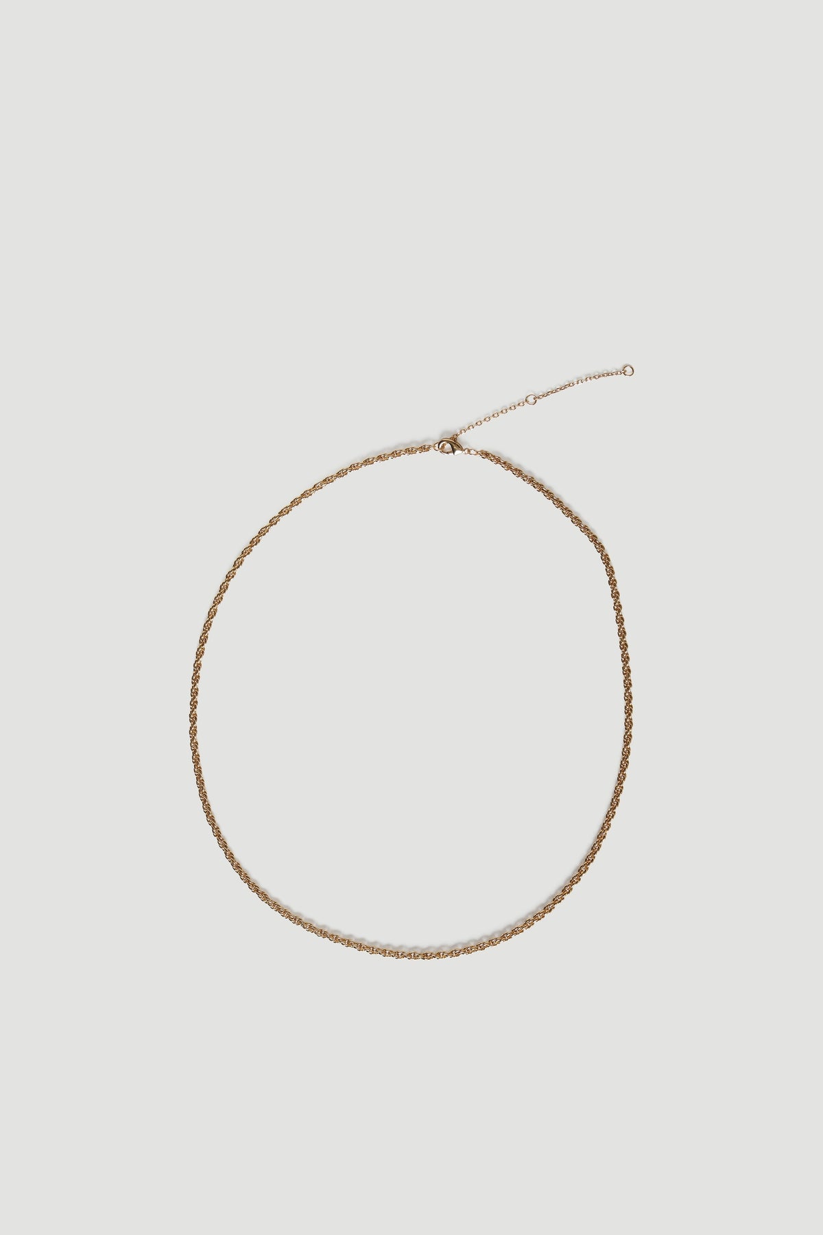 Gold twist chain necklace displayed against a neutral background
