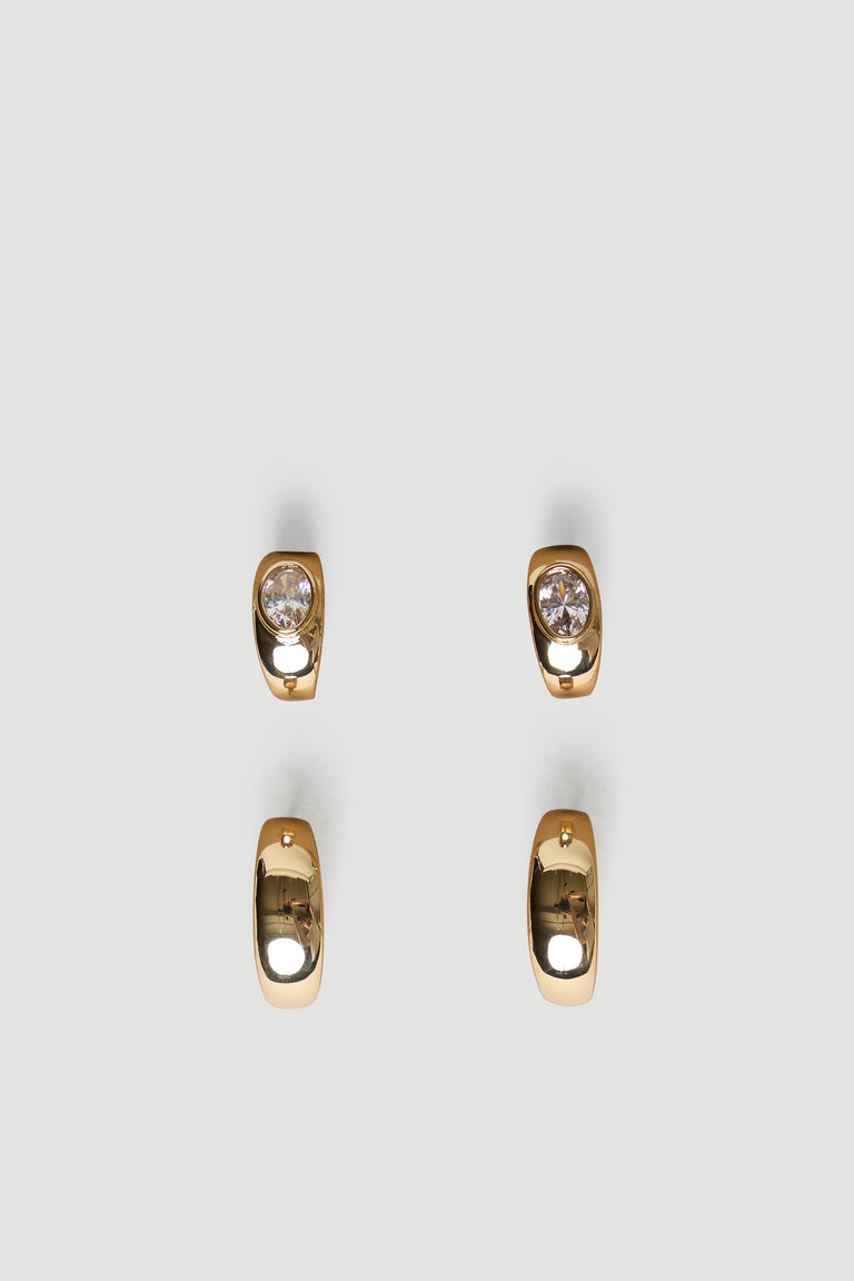 Pair of polished gold chunky hoop earrings with smooth finish, one set featuring sparkling clear stones for subtle shine.