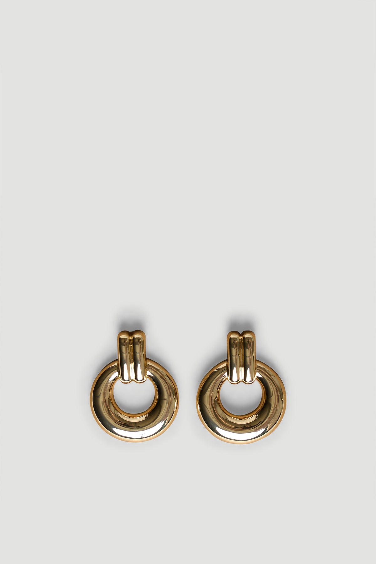 Polished gold hoop earrings with a bold door knocker design, perfect for adding effortless style to any look.
