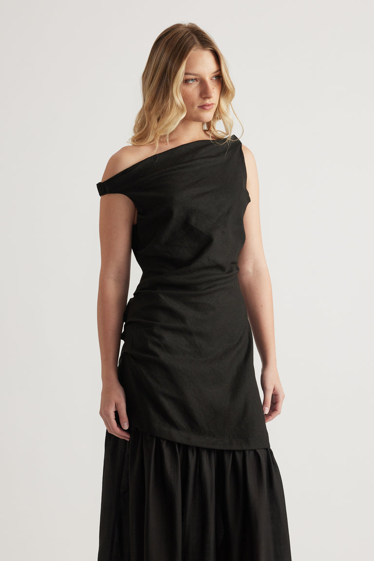 Woman wearing a black off shoulder maxi dress with a draped finish