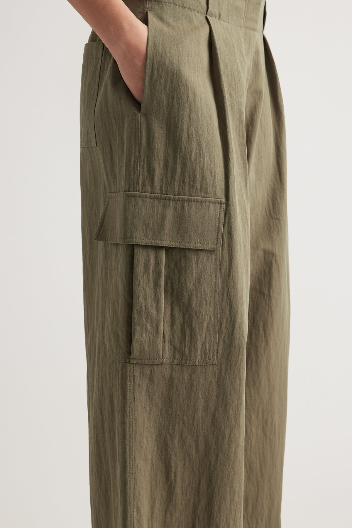 Olive cargo pants with a relaxed fit, pleat detail and large utility pockets