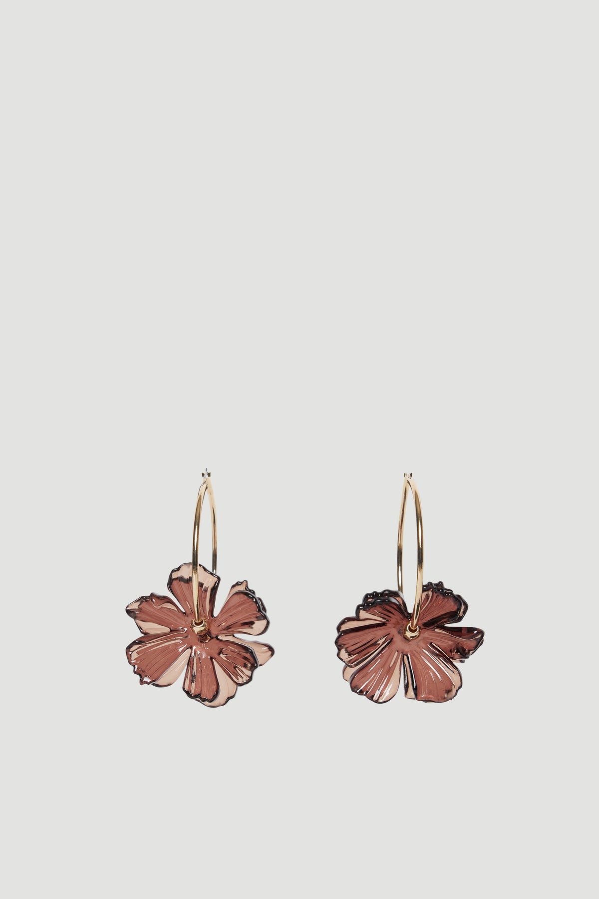 Gold hoop earrings with statement flower pendants in a two-level design
