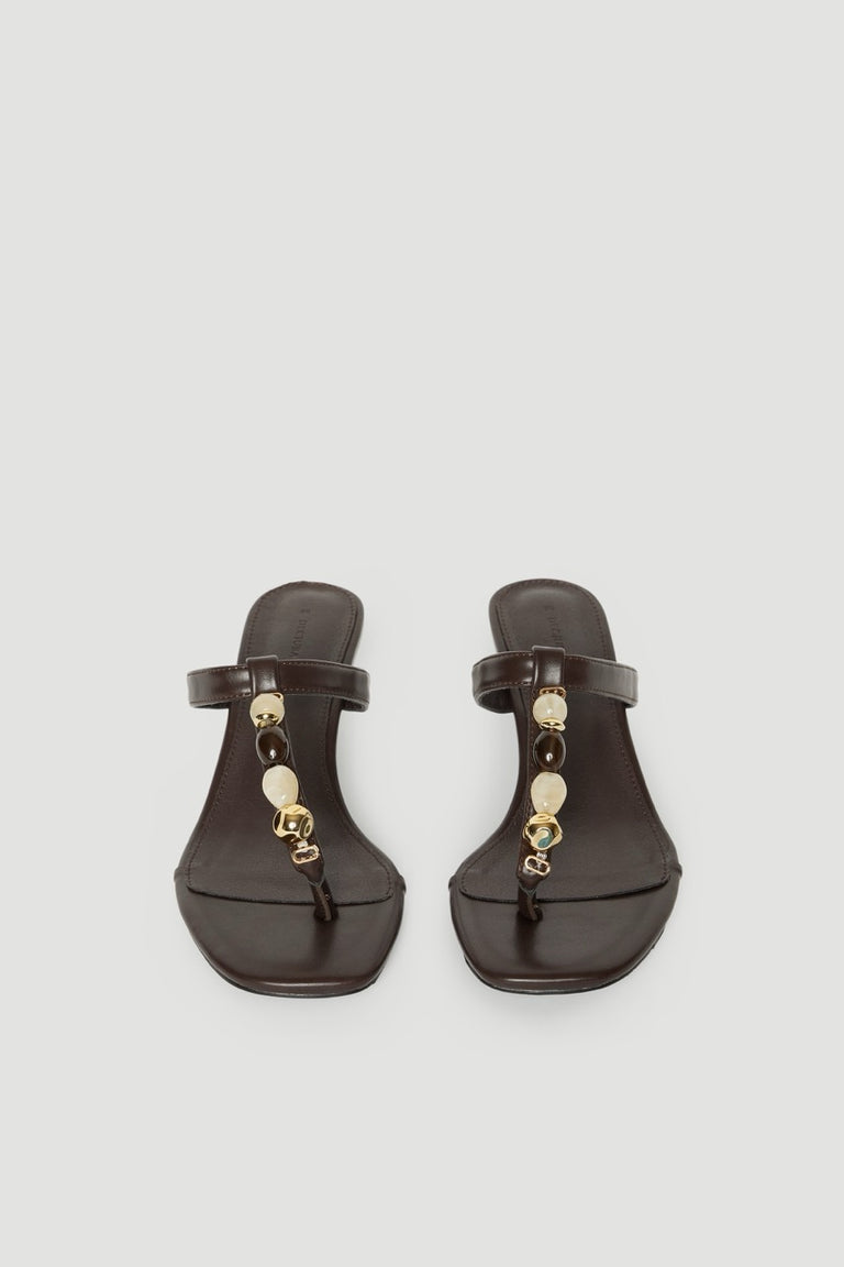 Pair of dark brown thong heels with thin straps, colourful gemstones and gold hardware
