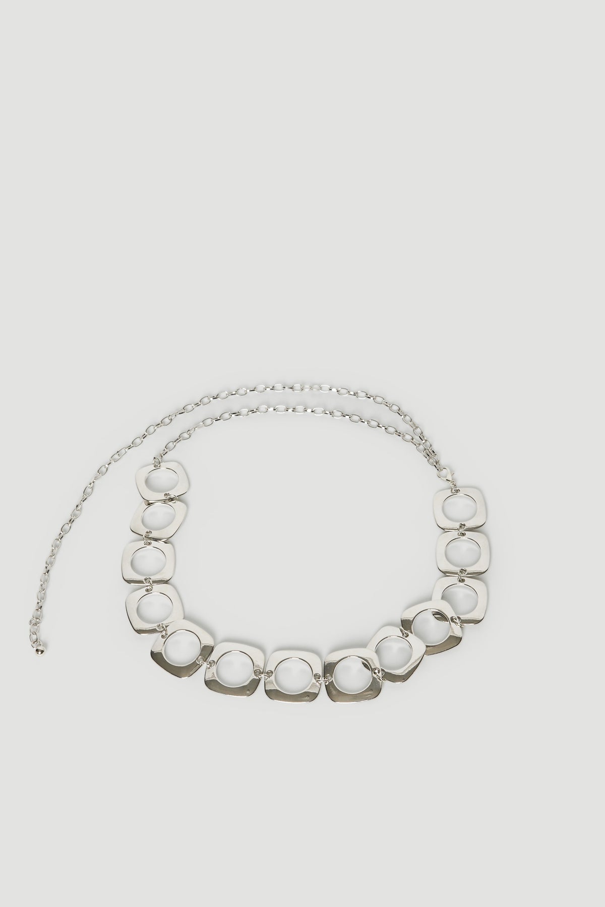 Silver chain belt with linked circular details and a lobster clasp