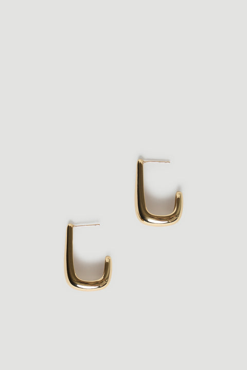 Pair of sleek gold open teardrop earrings with a smooth, modern curved design on a neutral background.