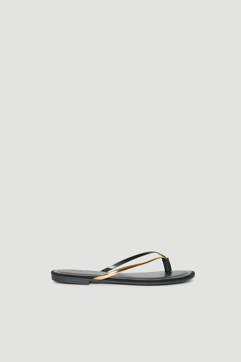 Black and gold thong sandal with thin straps and a padded footbed
