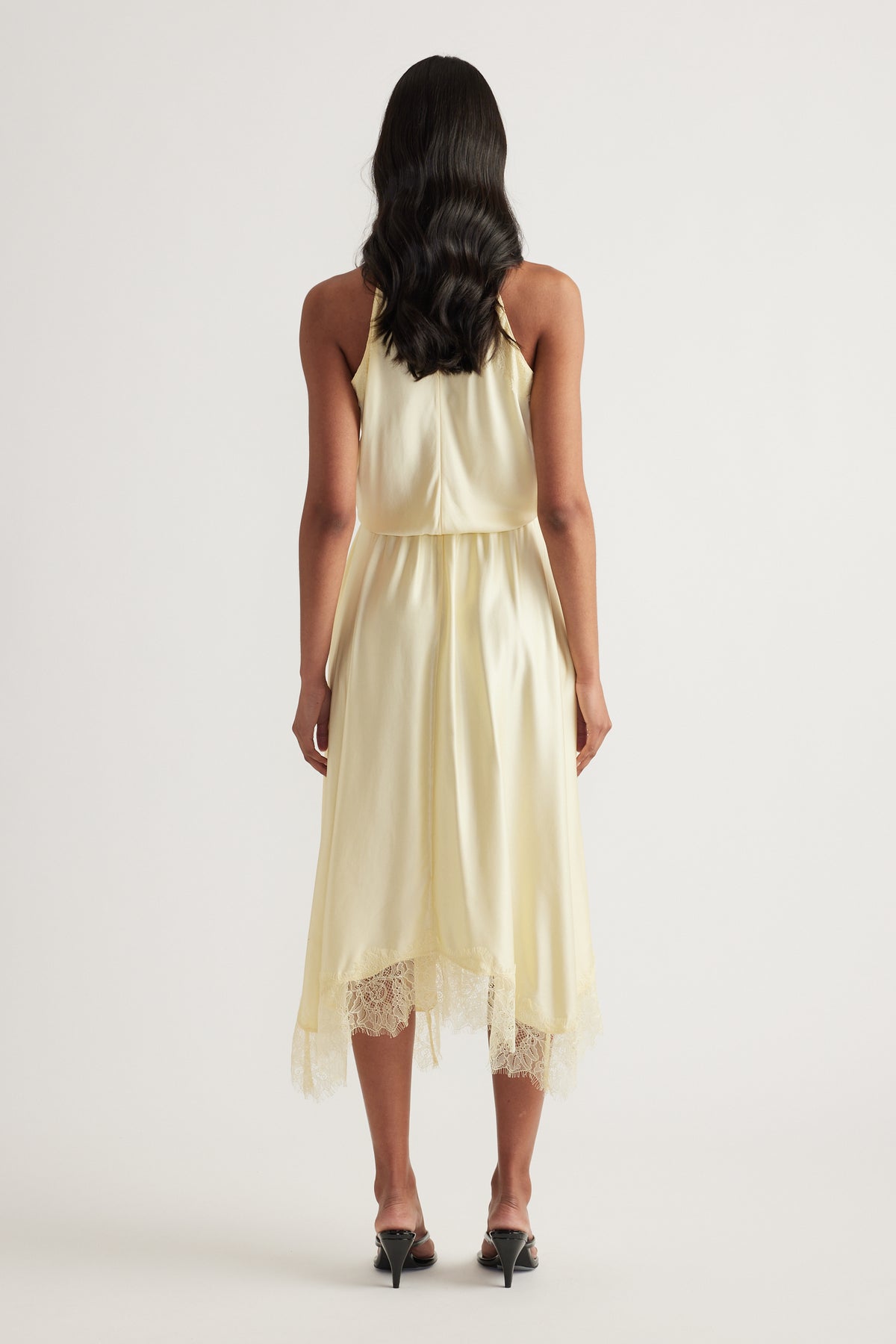 Cream halter midi dress with lace hem, shown from the back