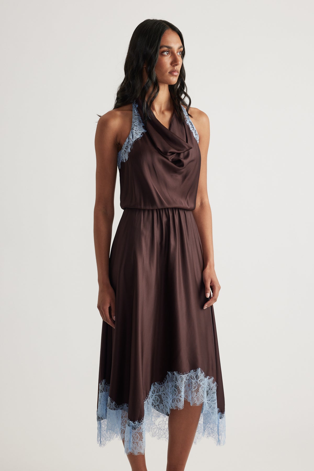 Woman wearing a chocolate brown halter midi dress with lace trim and a flowing A line skirt