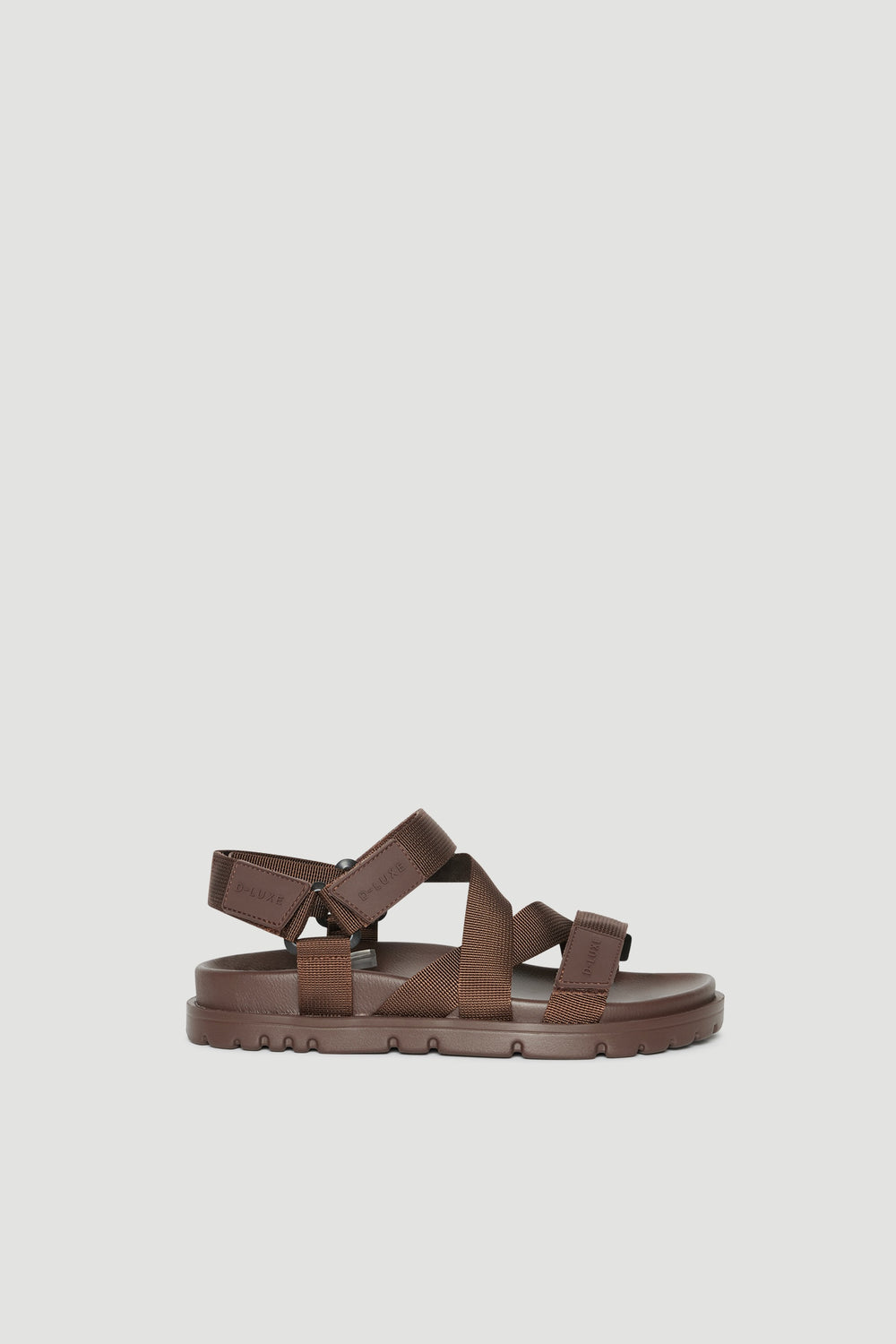 Brown crossover strap sandals with a padded sole and secure back strap
