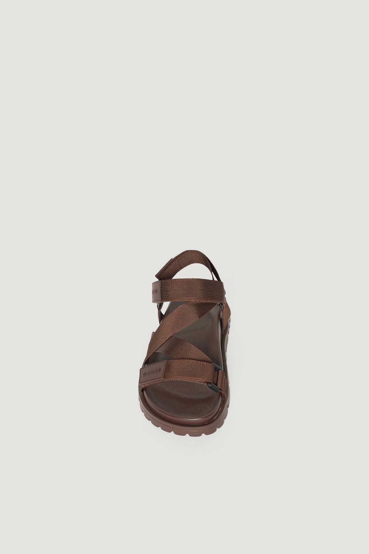 Brown crossover strap sandal with a padded sole and secure back strap