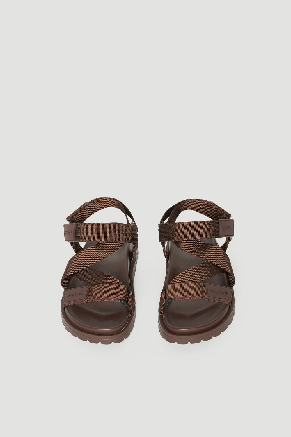 Pair of brown crossover strap sandals with padded soles and adjustable back straps