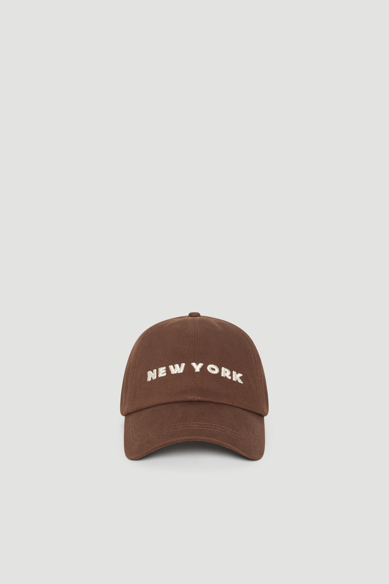 Brown baseball cap with embroidered New York lettering and a curved brim