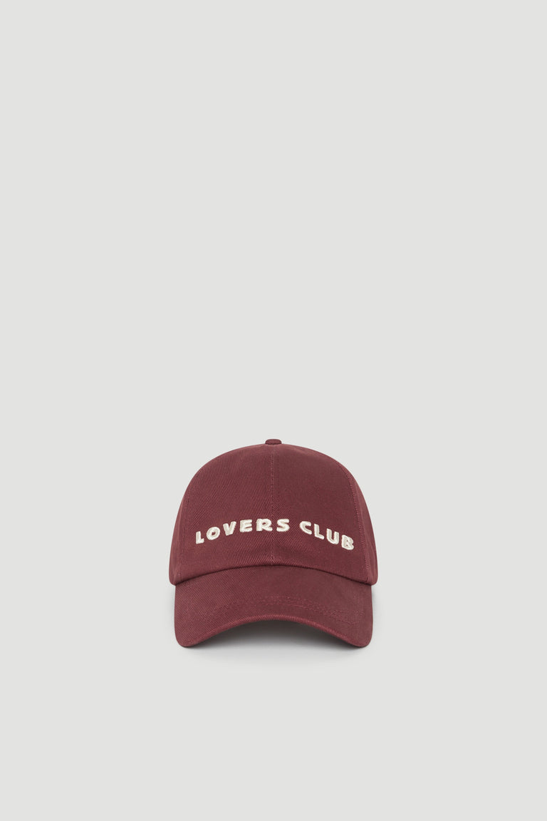 Burgundy baseball cap with embroidered Lovers Club logo and curved brim