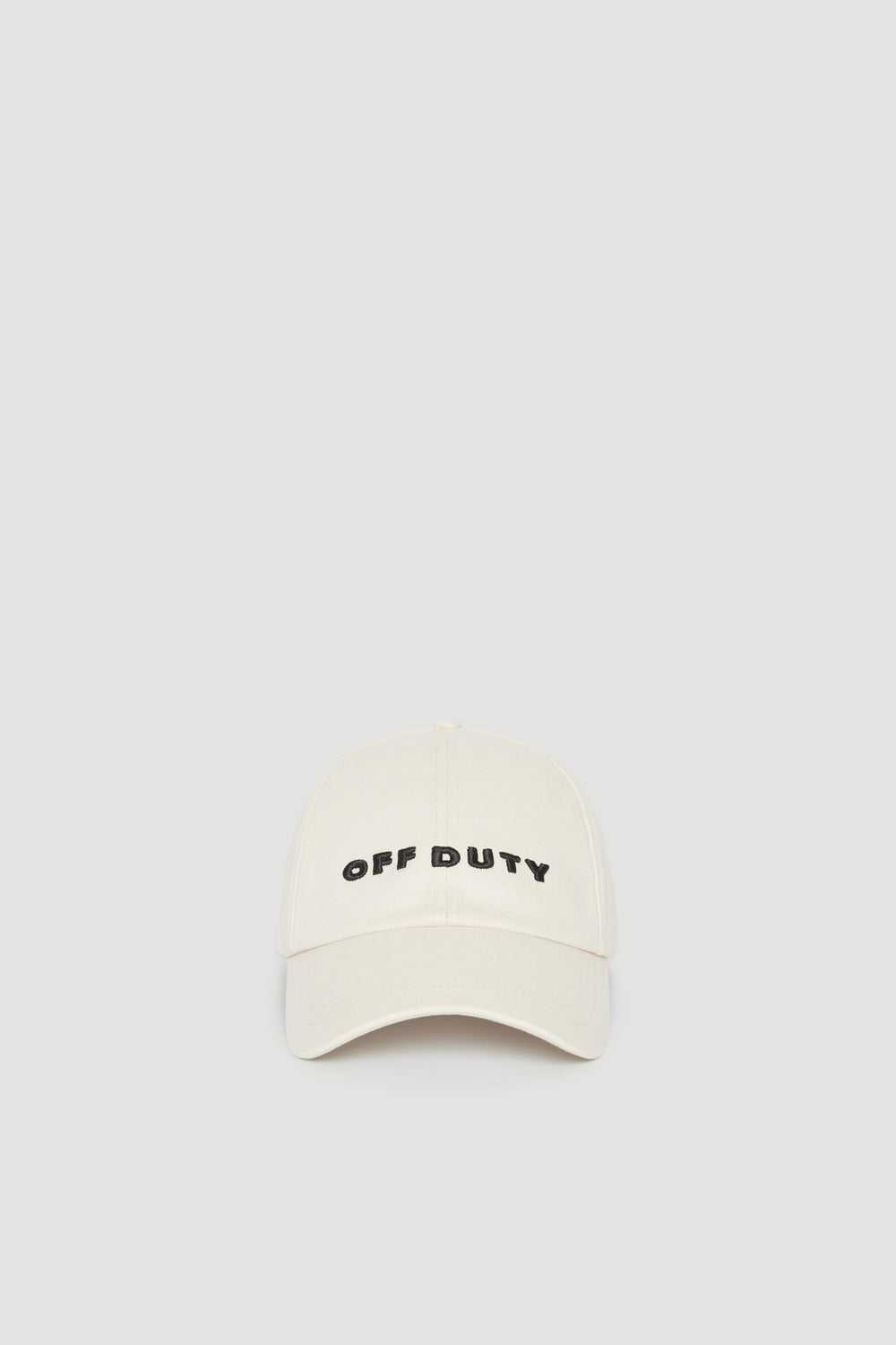 Cream baseball cap with embroidered Off Duty logo and curved brim