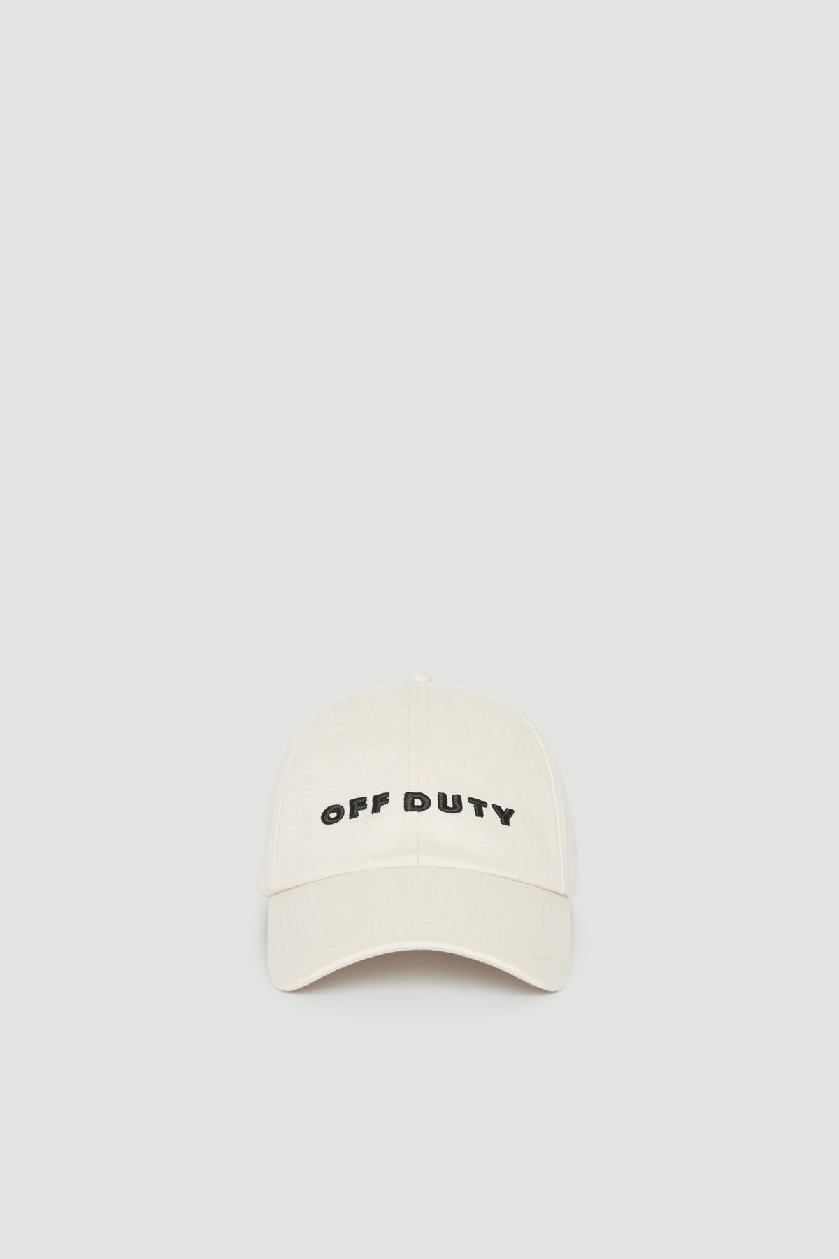Cream baseball cap with embroidered Off Duty logo and curved brim