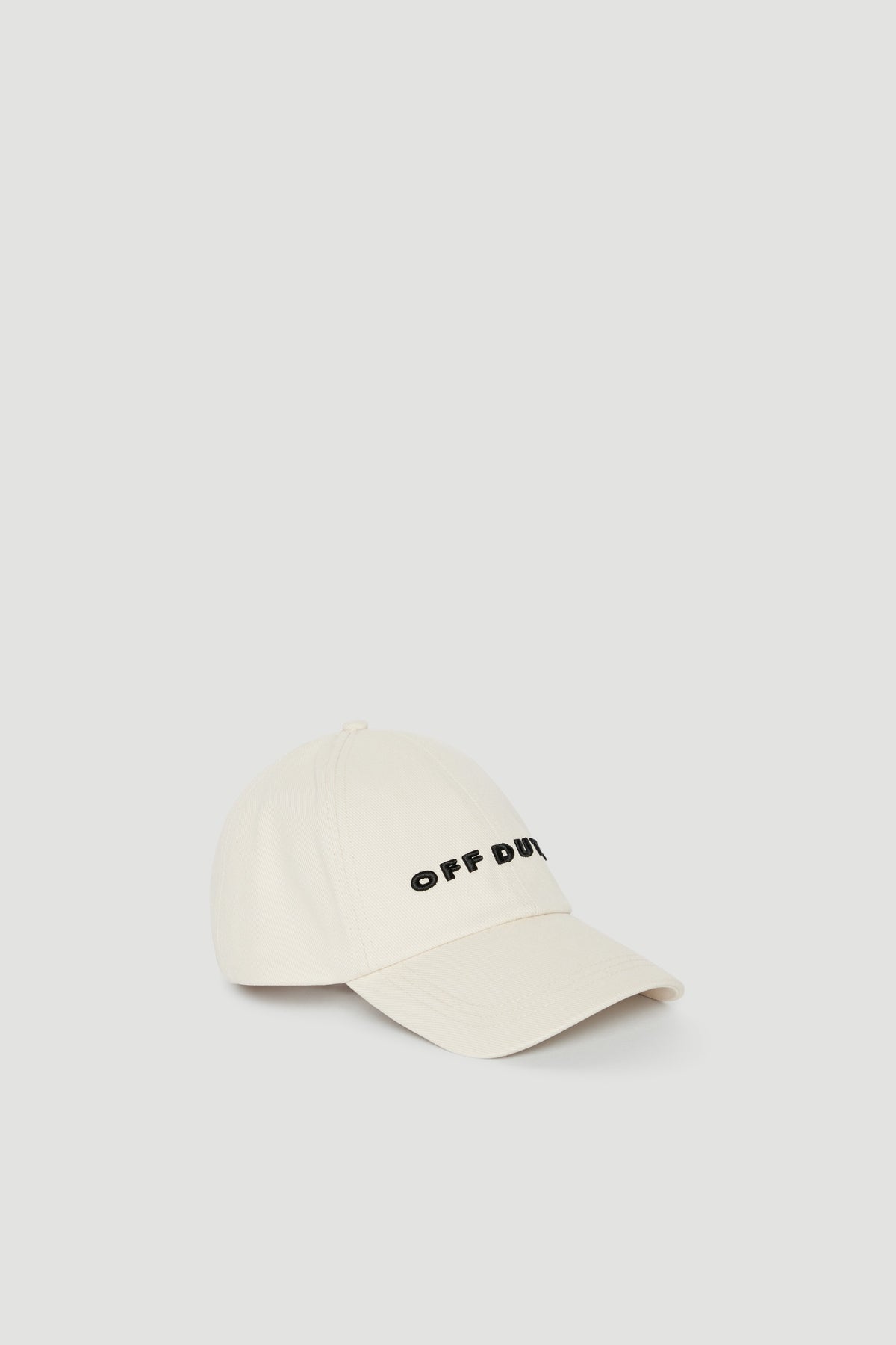 Cream baseball cap with black embroidered logo and curved brim
