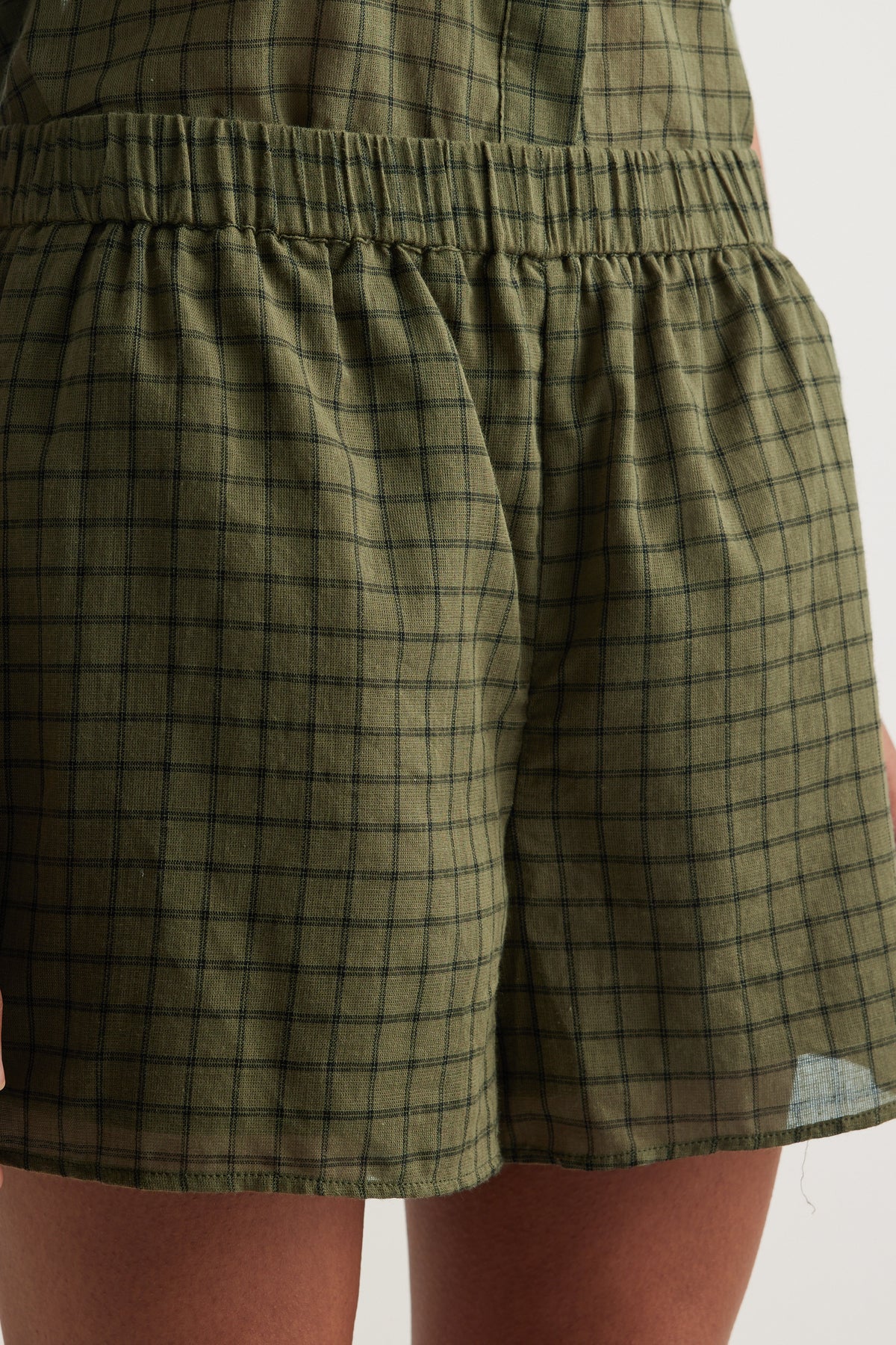 Olive plaid shorts with an elasticated waist, wide legs and an above knee hem