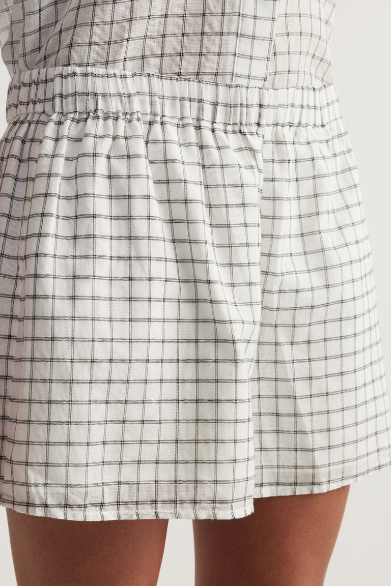 Close up of lightweight plaid shorts with an elasticated waist, wide legs and an above knee hem