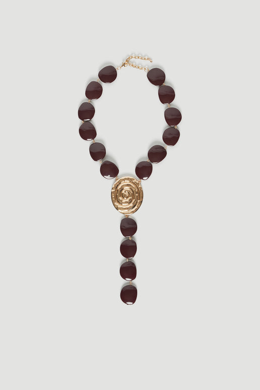 Chocolate bead lariat necklace with a gold shell pendant and lobster clasp closure