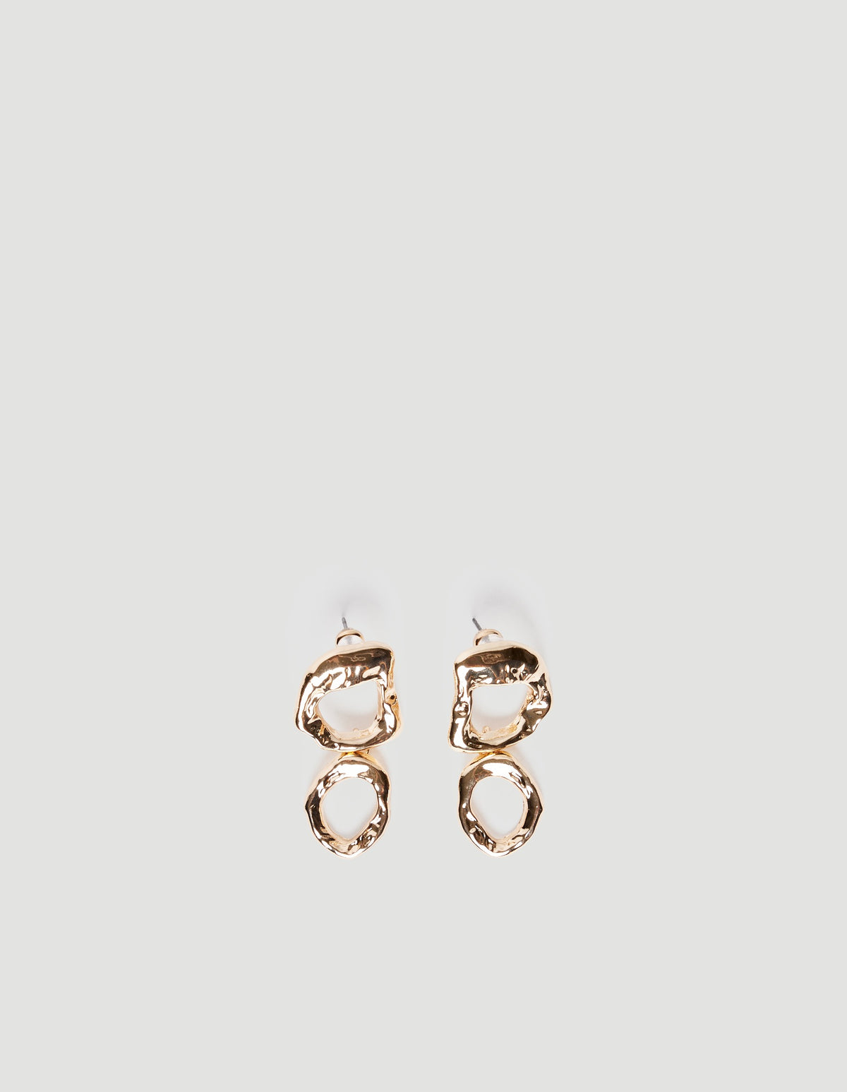 Pair of shiny gold-tone open drop earrings featuring irregular double circle textured studs on a plain background