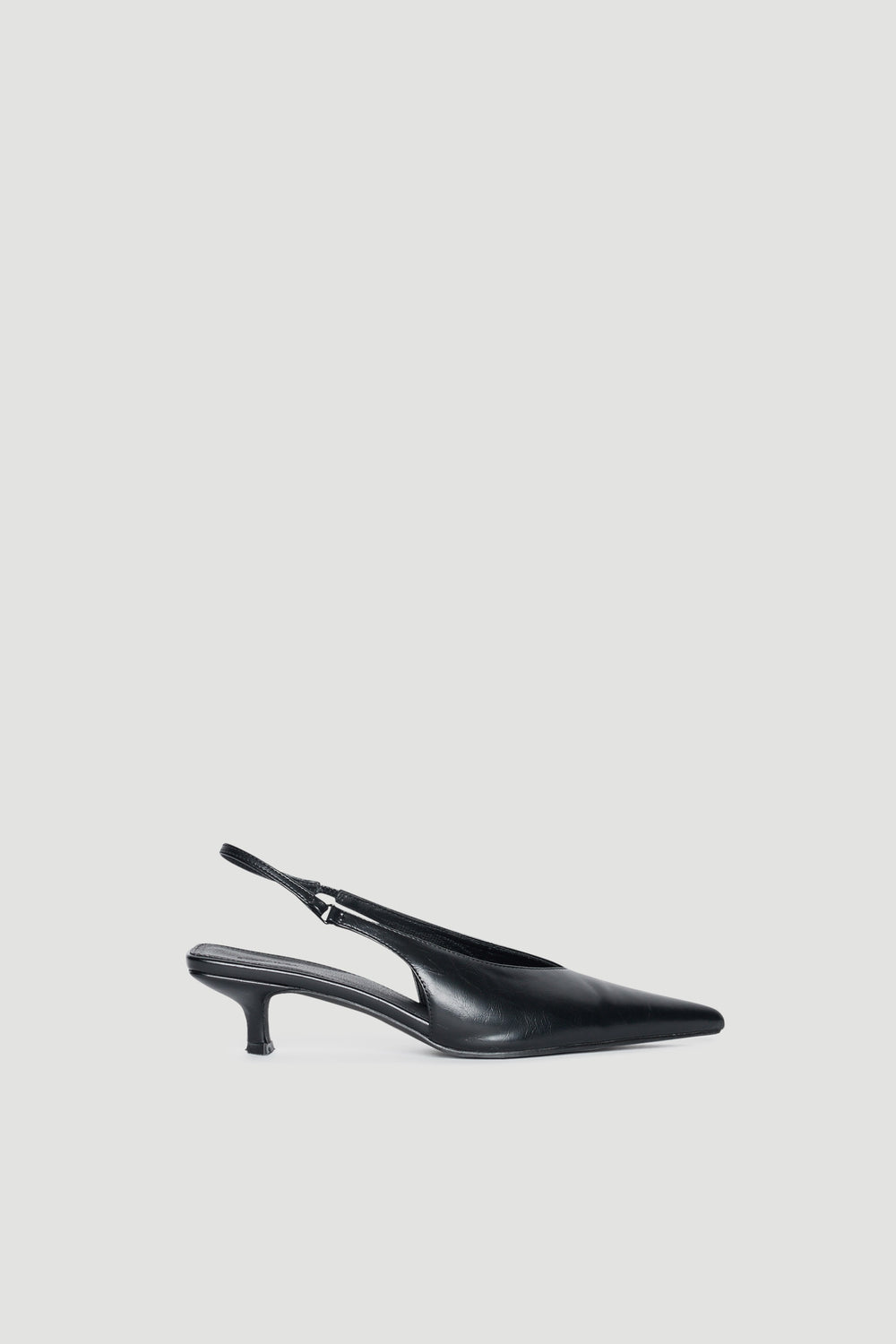 Black pointed toe slingback kitten heels with a sleek finish