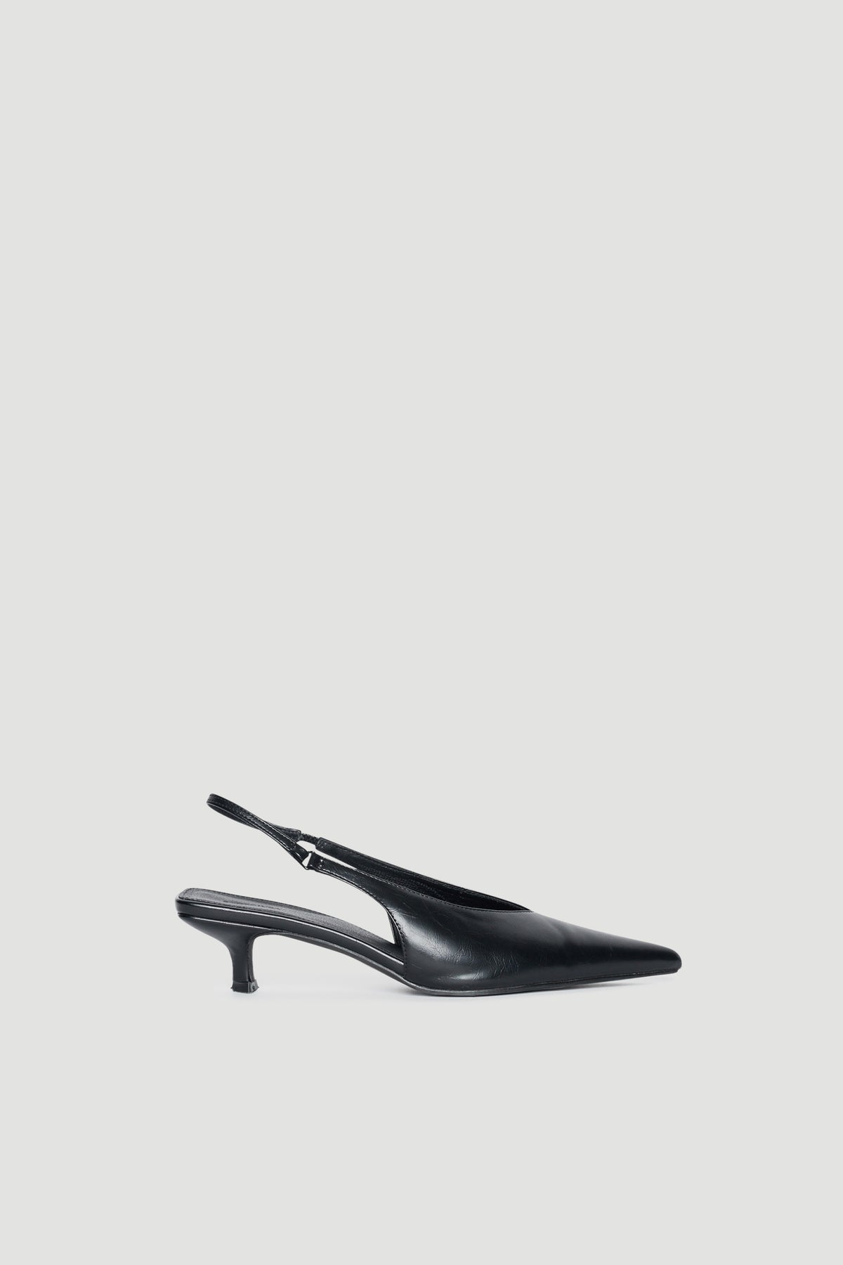 Black pointed toe slingback kitten heels with a sleek finish