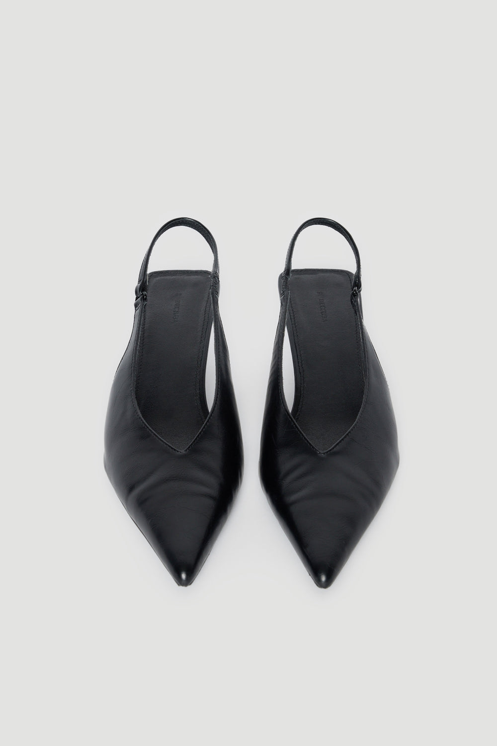 Pair of black pointed toe slingback kitten heels with slim straps