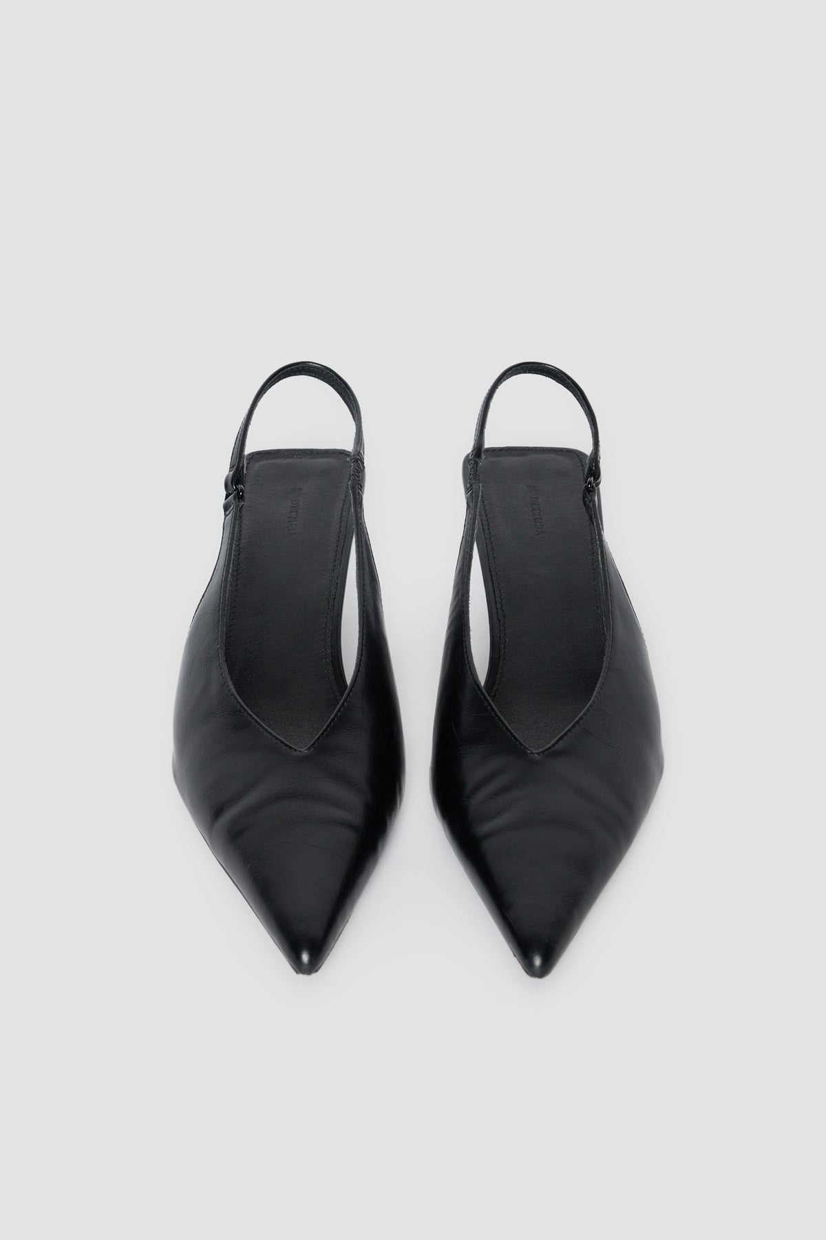 Pair of black pointed toe slingback kitten heels with slim straps