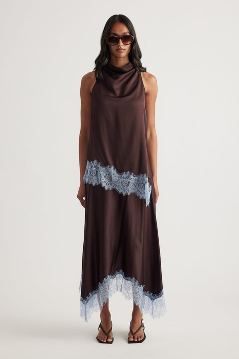 Woman wearing a chocolate brown satin top and lace trimmed handkerchief midi skirt with sunglasses and strappy sandals