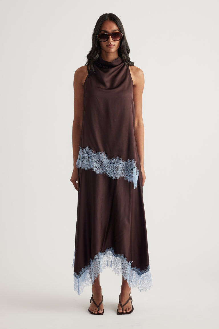 Woman wearing a chocolate brown satin top and lace trimmed handkerchief midi skirt with sunglasses and strappy sandals